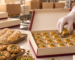 Assorted baklava, maamoul and barazek in cream and burgundy packaging.